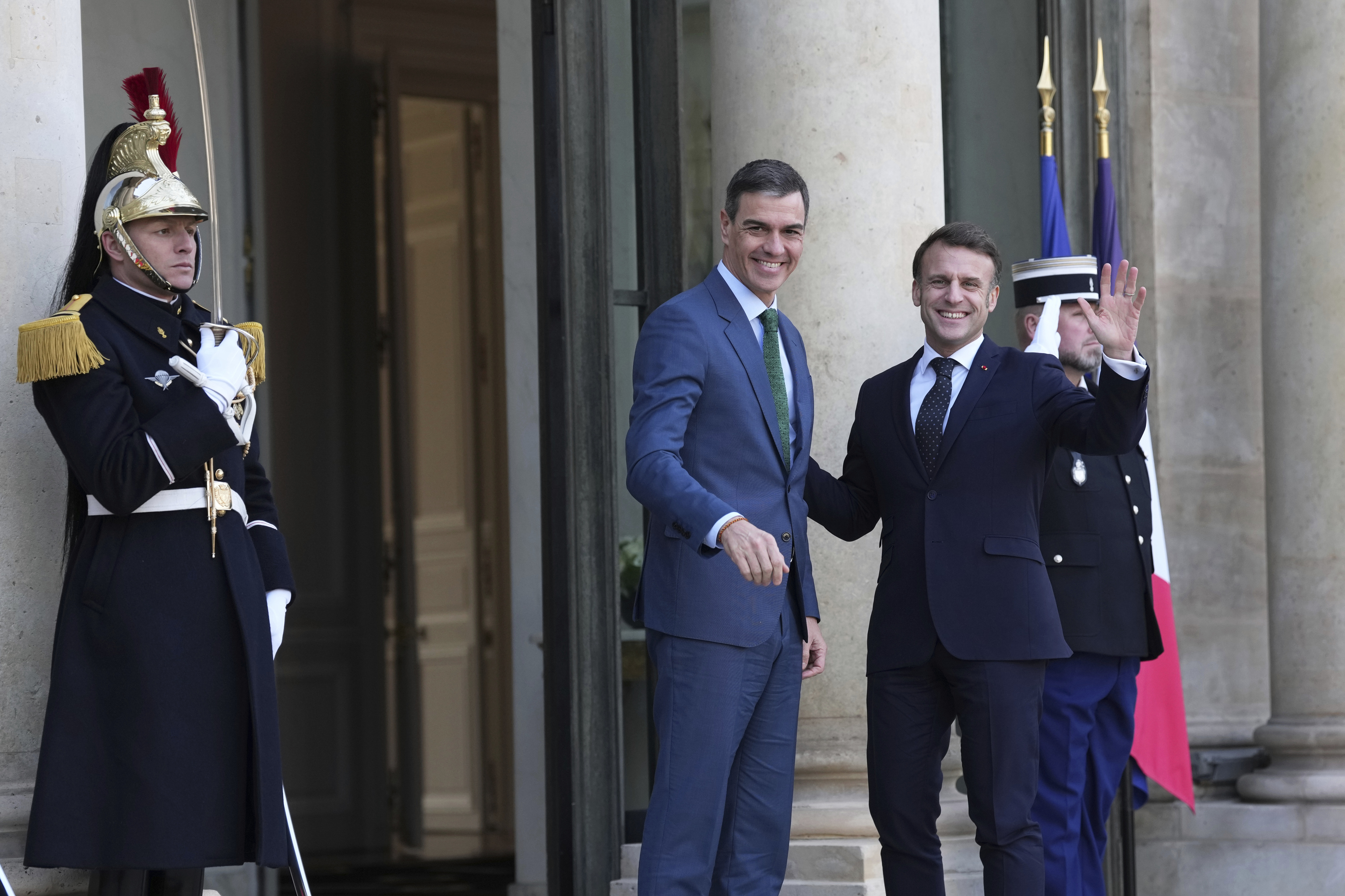 French President Emmanuel Macron, right, greets Spain's Prime Minister Pedro Sanchez.