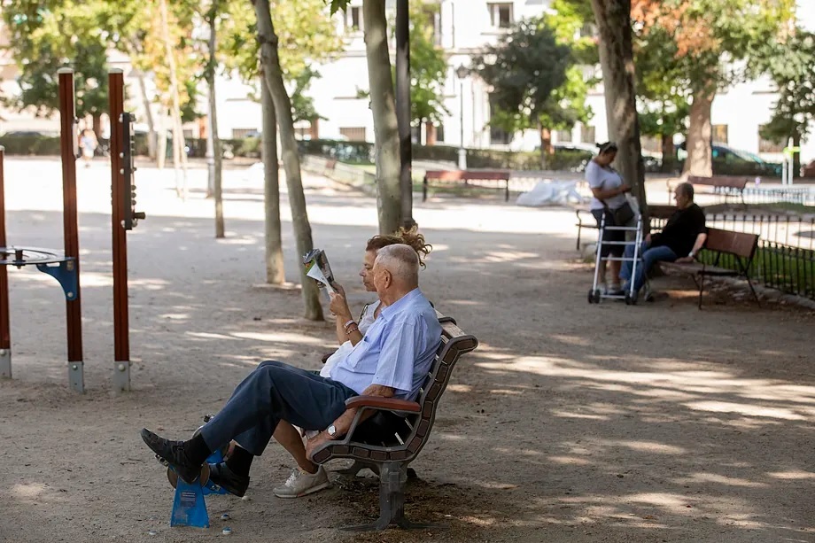 A group of people sitting in the shade, last August