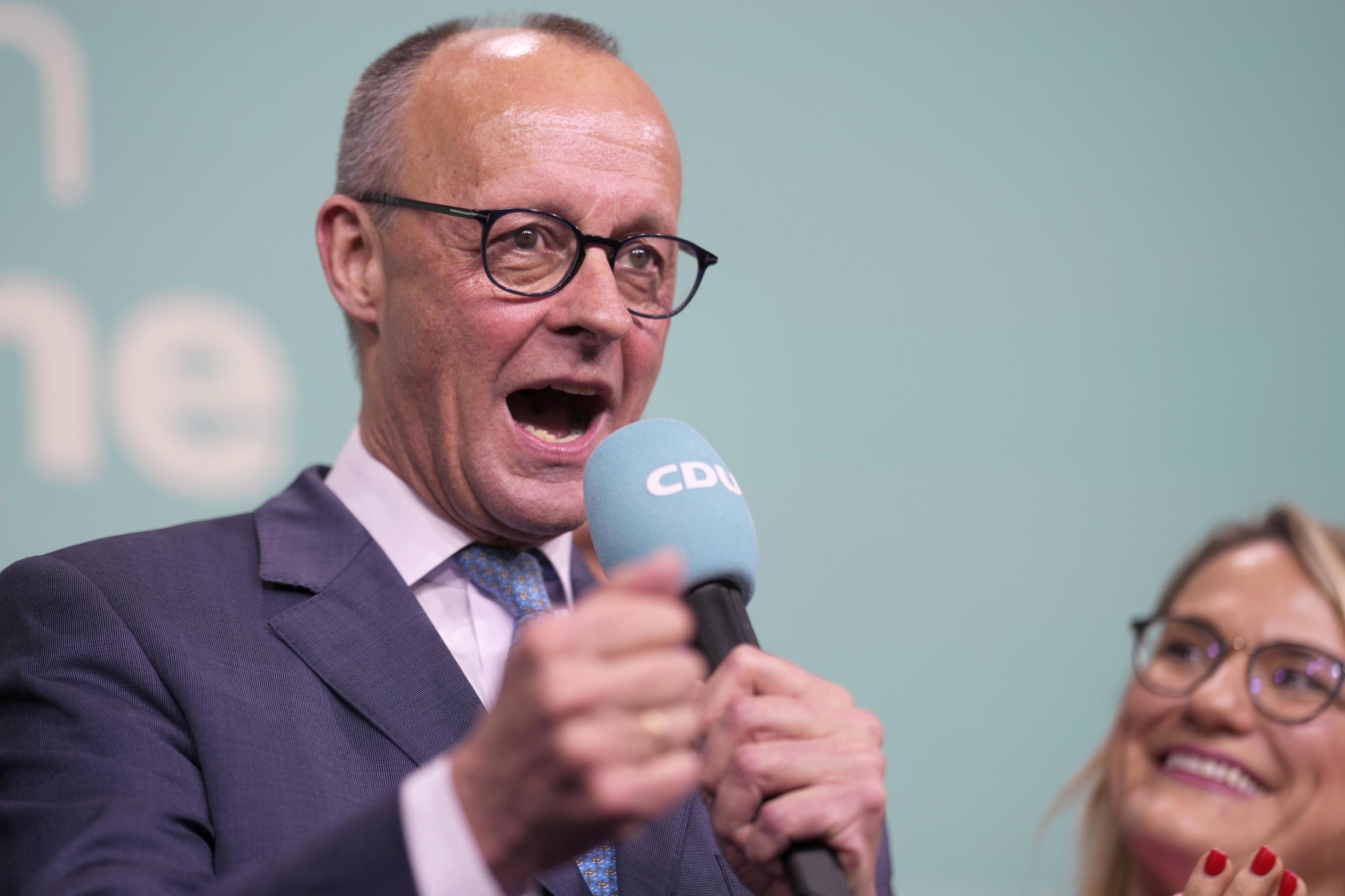 Merz gestures while addressing supporters at the party headquarters in Berlin.