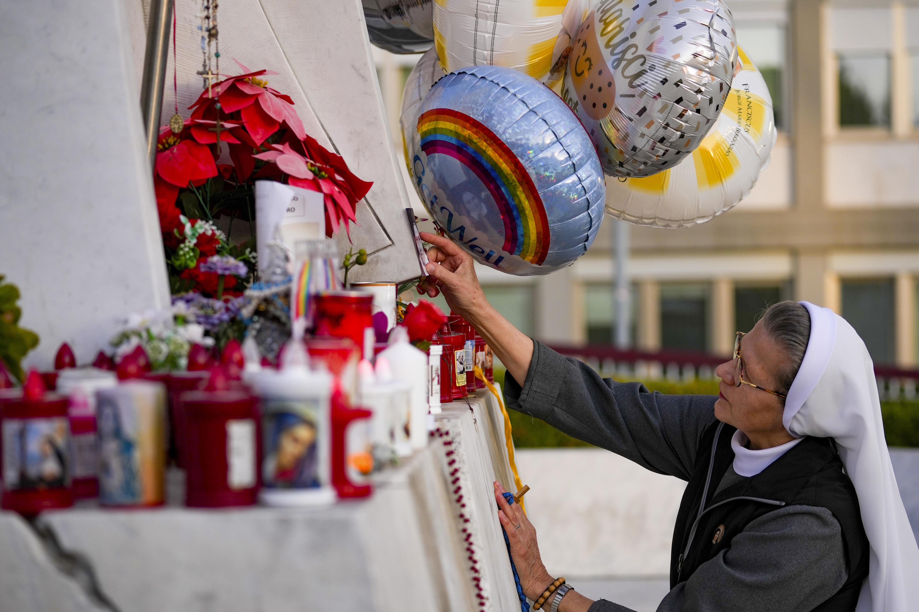 A nun prays for Pope Francis in front of the Agostino Gemelli Polyclinic.