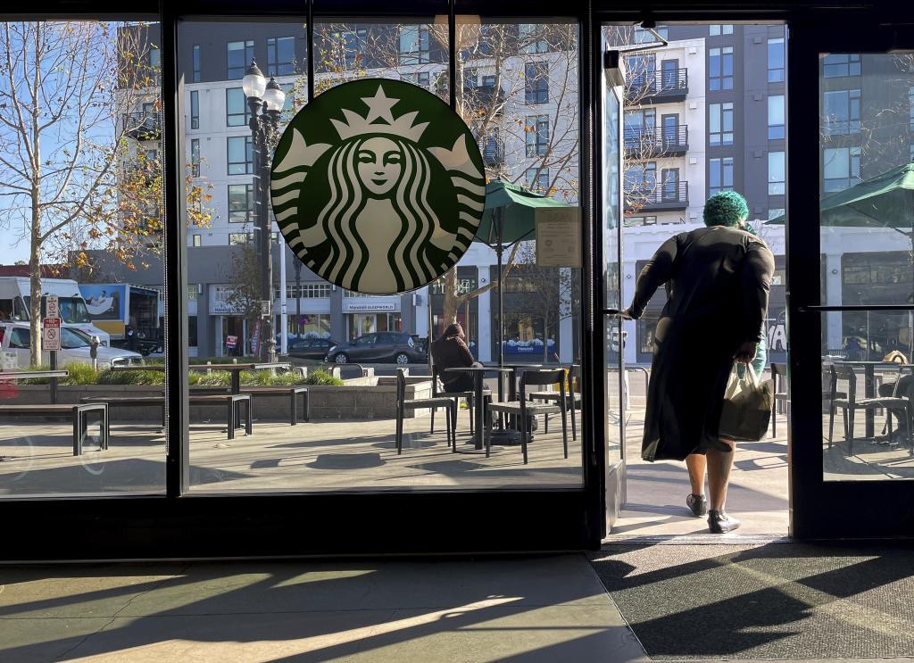 A costumer exits a Starbucks store in Oakland