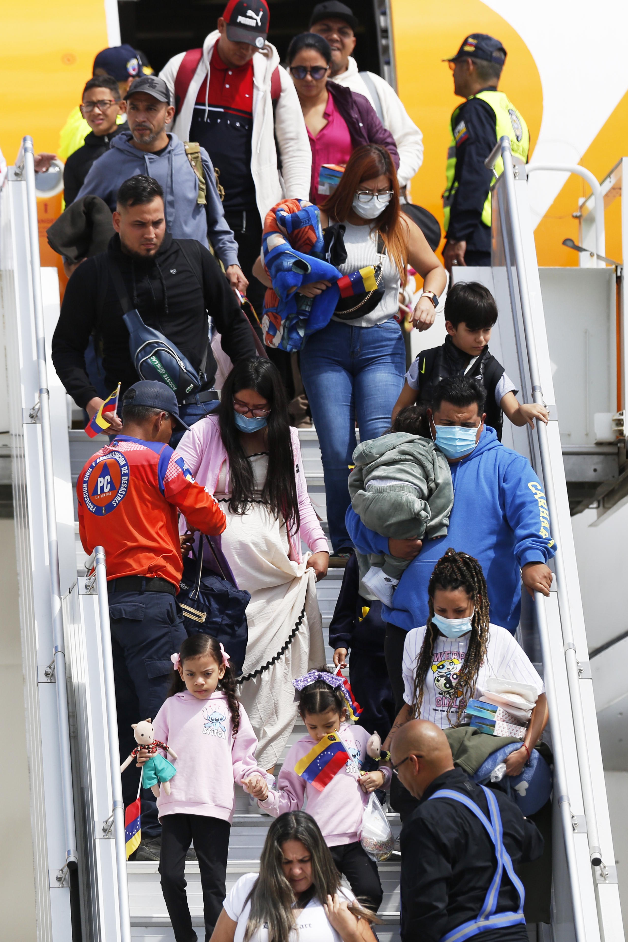 Venezuelan migrants deported from the United States deplane at Simon Bolivar International Airport in Maiqueta, Venezuela.