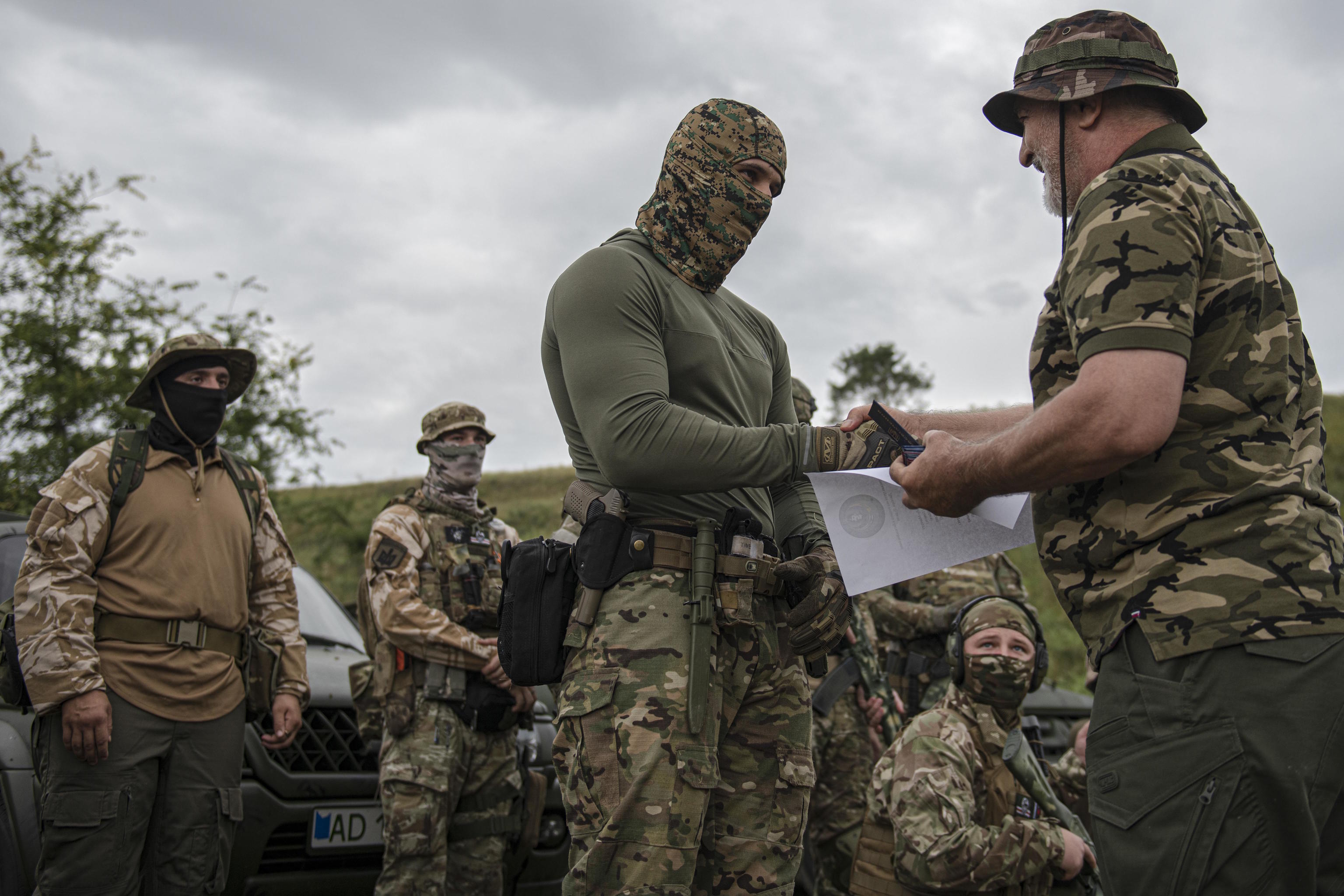 A volunteer soldier takes the oath on the training area outside Kyiv.