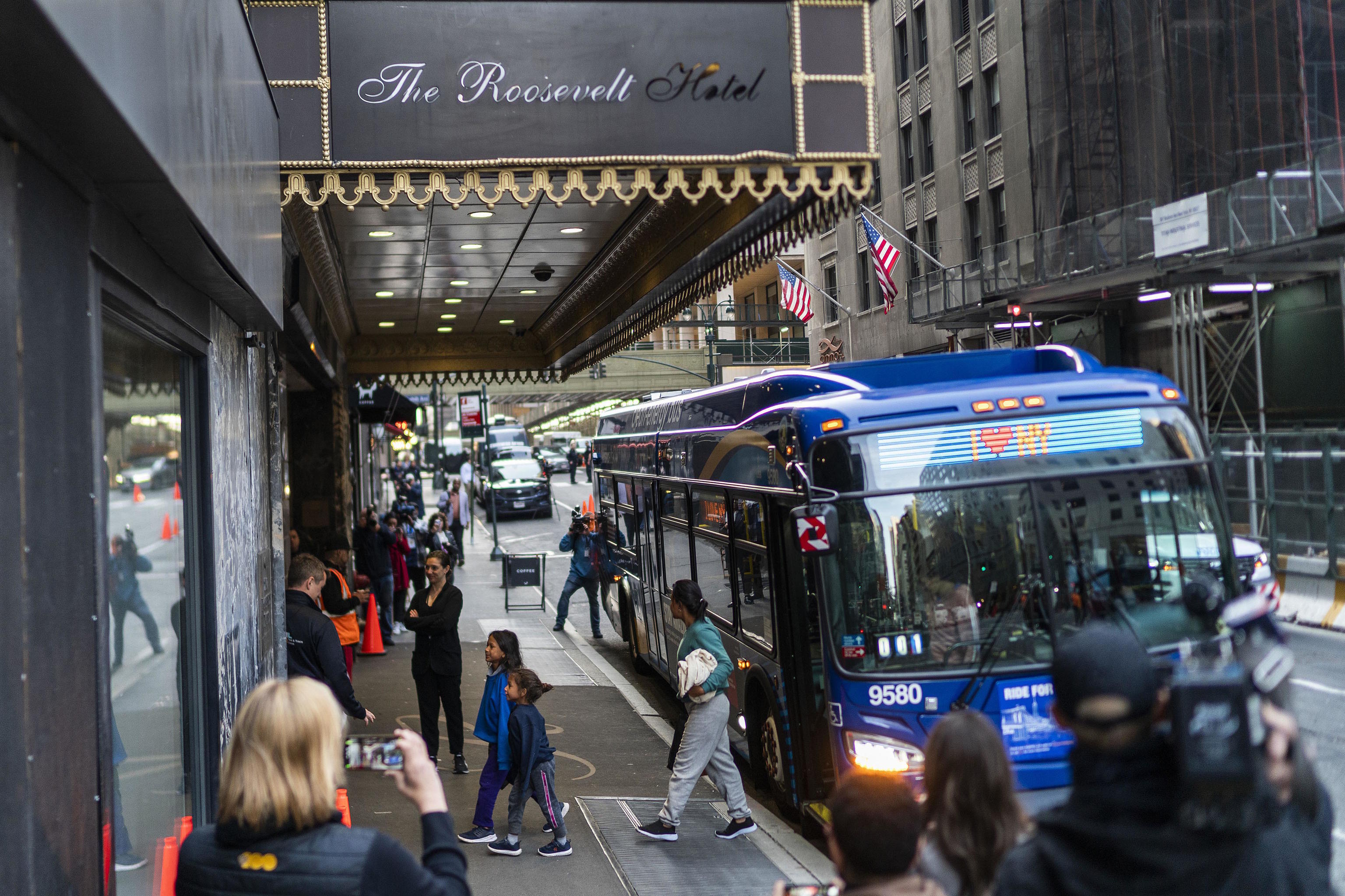 Asylum seekers arrive at the Roosevelt Hotel in New York.