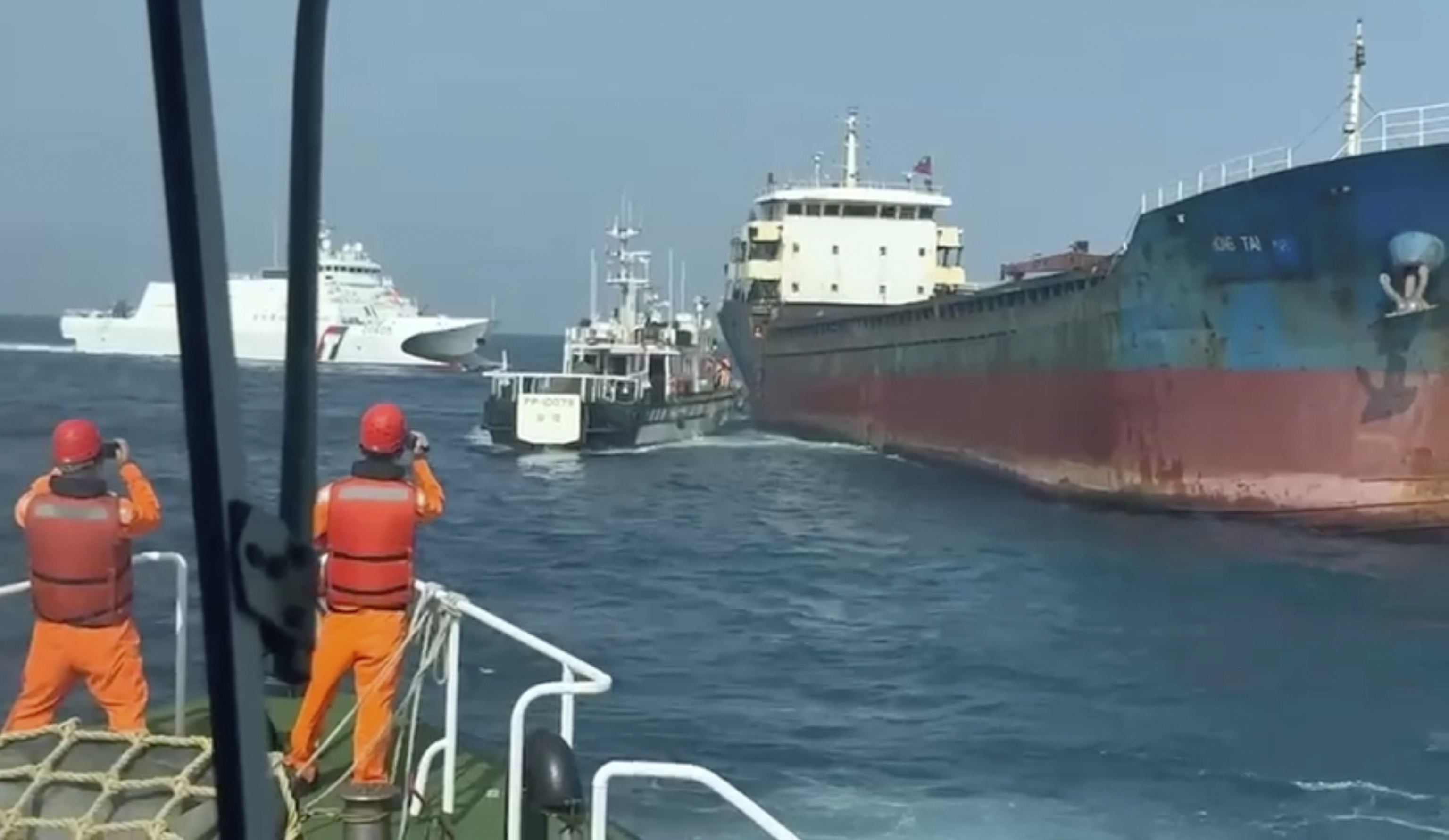 the Taiwan Coast Guard, Taiwanese Coast Guard vessels prepare to board Togolese-flagged cargo ship Hongtai.