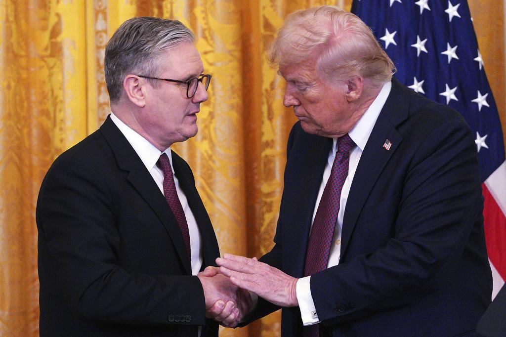 Britain's Prime Minister Starmer, left, and U.S. President Trump shake hands.