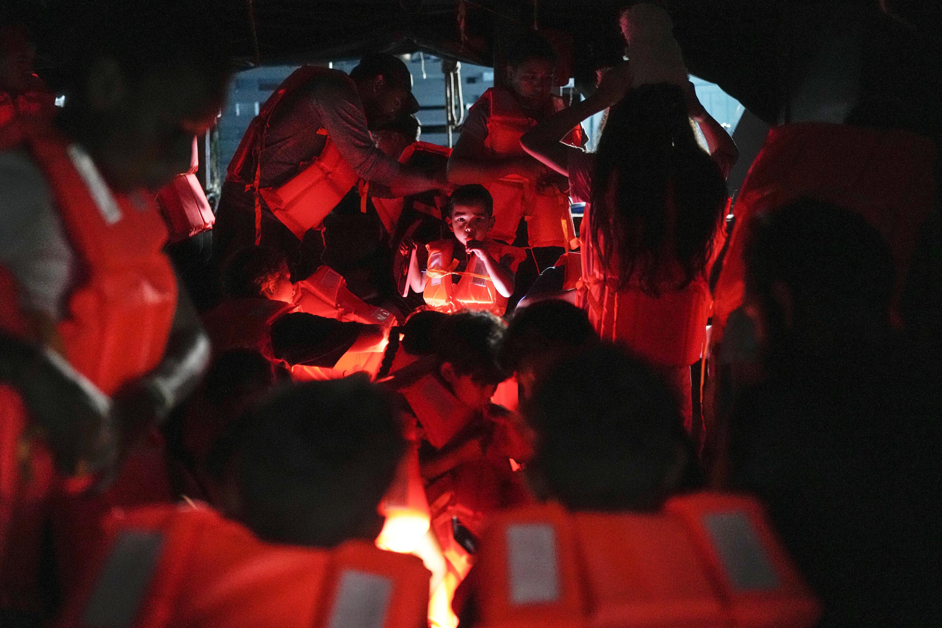 Migrants board a boat at the Caribbean coastal village of Miramar, Panama.