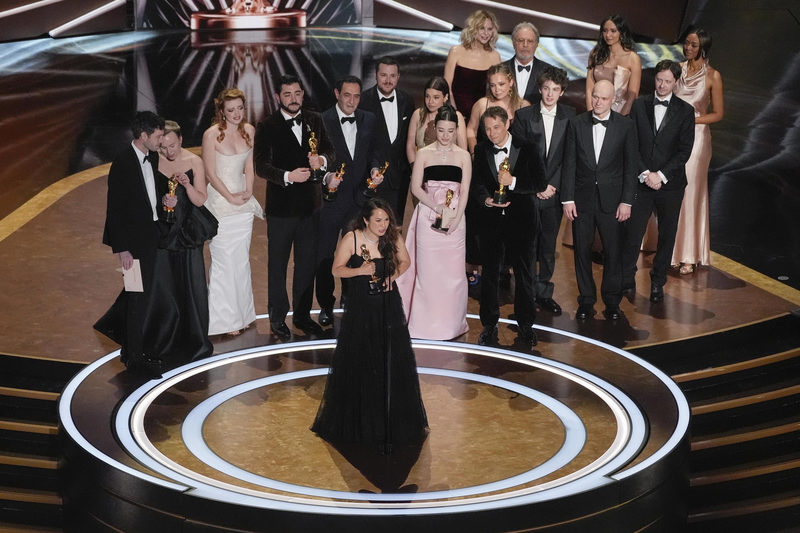 Samantha Quan, front center, accepts the award for best picture for "Anora" during the Oscars.