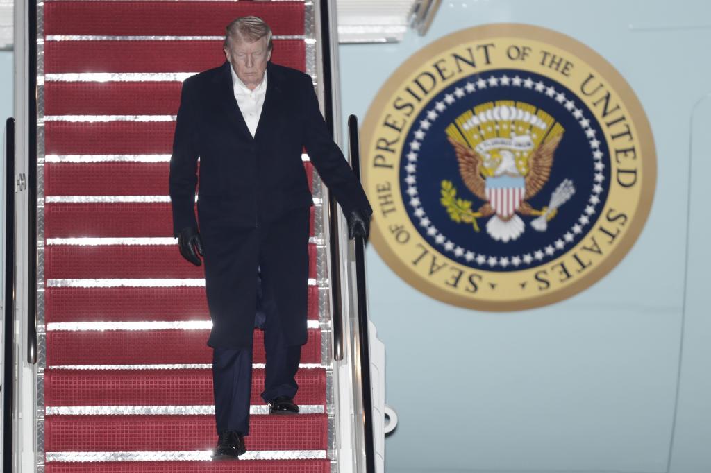 President Donald Trump walks down the stairs of Air Force One