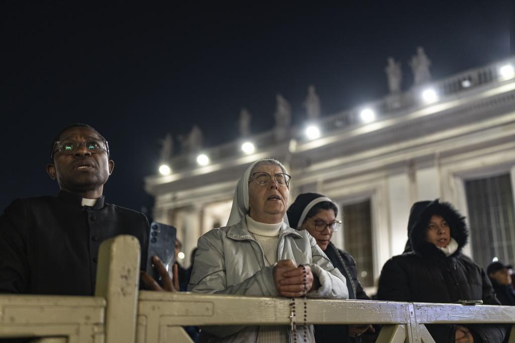 Catholic faithful attend a nightly rosary prayer for the health of Pope Francis in St. Peter's Square at the Vatican