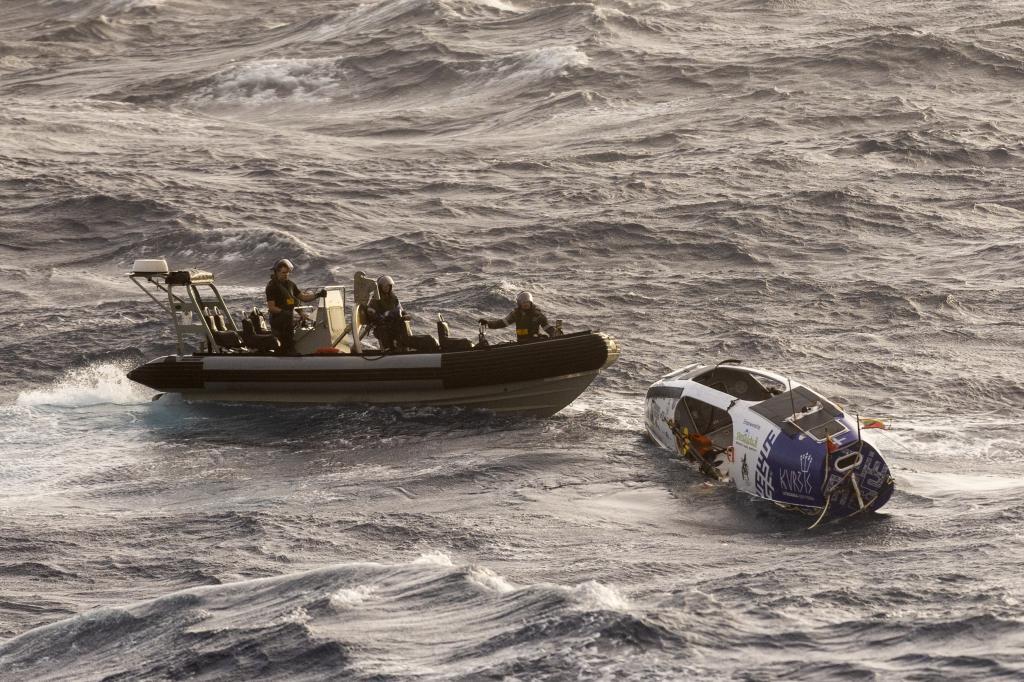 Australian Defense Force Australian Navy sailors from HMAS Choules use an inflatable boat to rescue Lithuanian rower Aurimas Mockus,