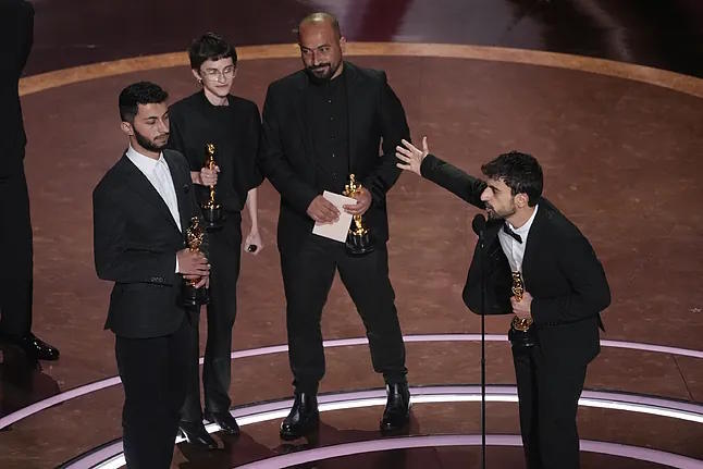 Basel Adra, from left, Rachel Szor, Hamdan Ballal, and Yuval Abraham accept the Oscar for Best Documentary.