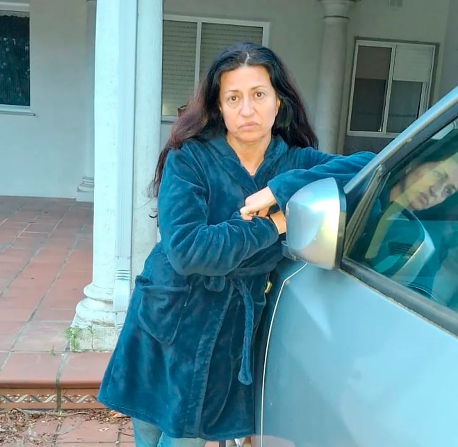 Pilar Pardo next to the car in front of her usurped house.