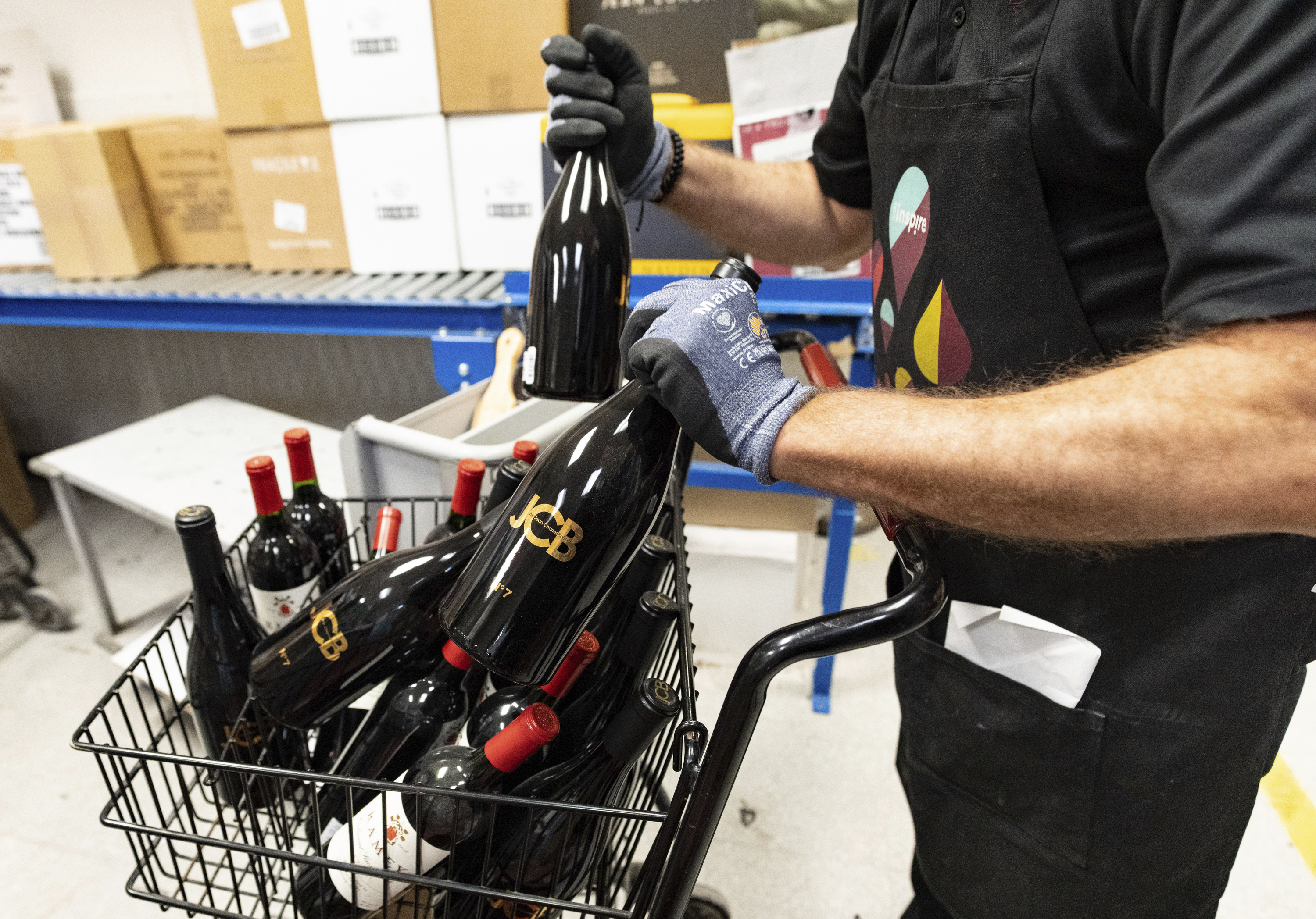 An employee removes American wines from an SAQ liquor store.