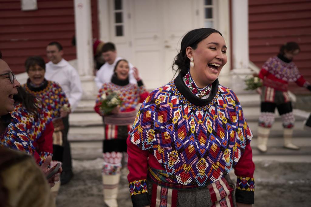 Malu Schmidt laughs next to her friends after getting married at the church of our Savior in Nuuk, Greenland