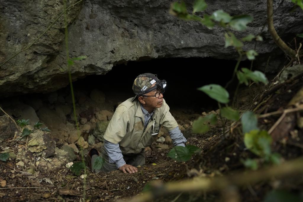 Takamatsu Gushiken leaves a cave after a session of searching for the remains of those who died during the Battle of Okinawa