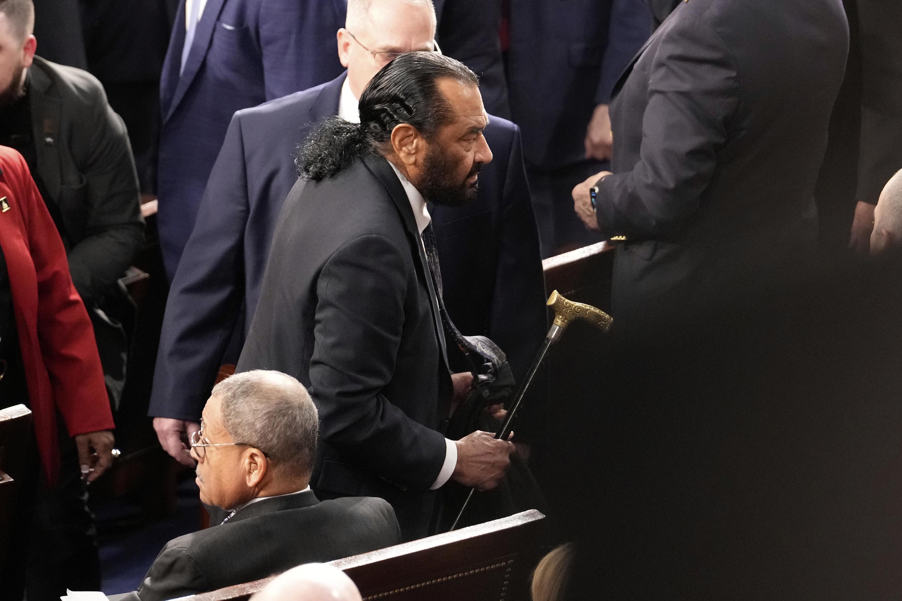 Rep. Al Green, D-Texas, is escorted out.