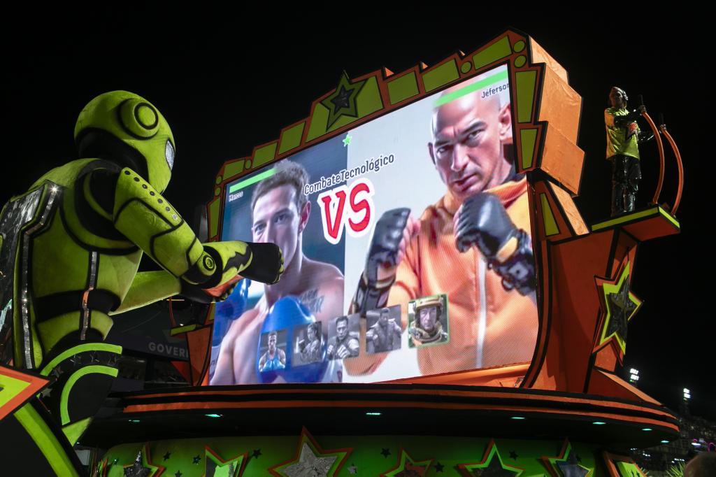 A performer from the Mocidade samba school directs a float alongside artificial intelligence images of Meta CEO Mark Zuckerberg, left, and Amazon CEO Jeff Bezos