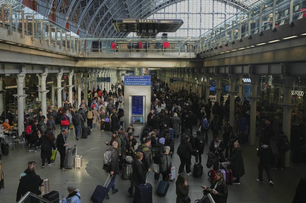 Passengers queue and wait near departures for Eurostar services at St Pancras International station in London