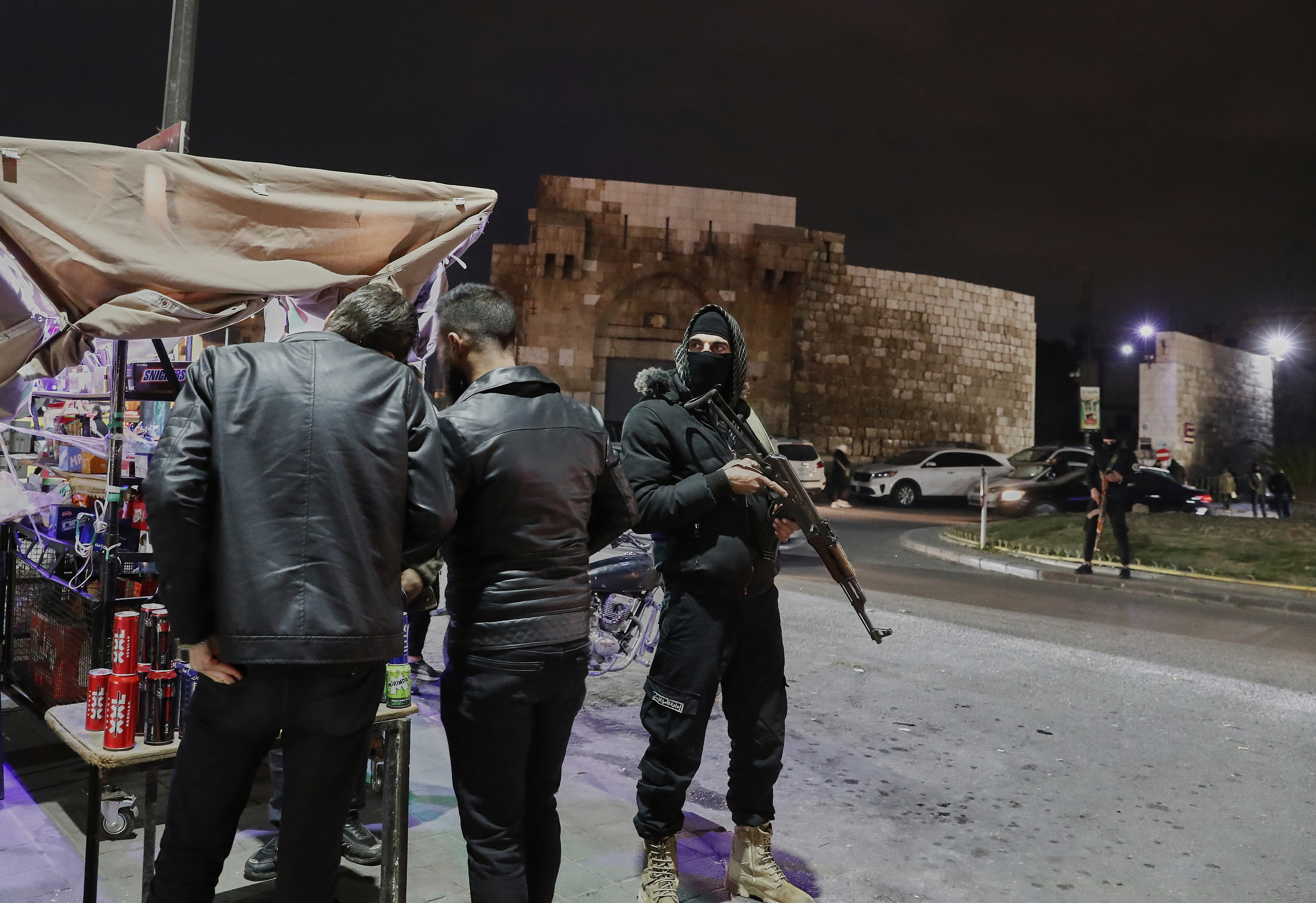 Members of the Syrian government security forces deploy at a street in Damascus, Syria.