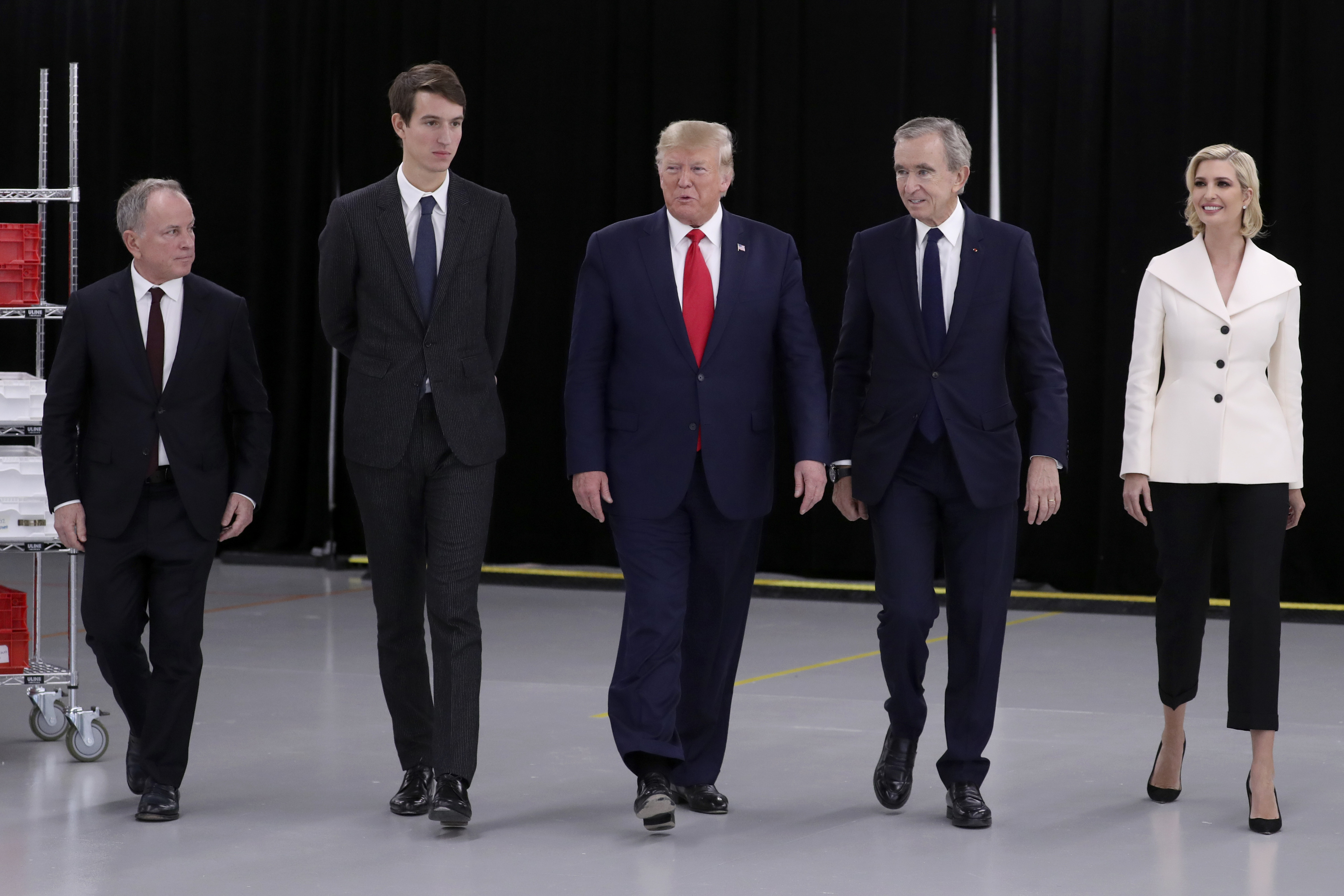 President Donald Trump walks with, from left, Michael Burke of LVMH, Alexandre Arnault, Bernard Arnault, chief executive of LVMH and Ivanka Trump.