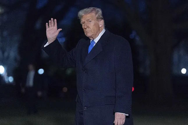 Donald Trump greets the media as he walks through the South Lawn of the White House in Washington.