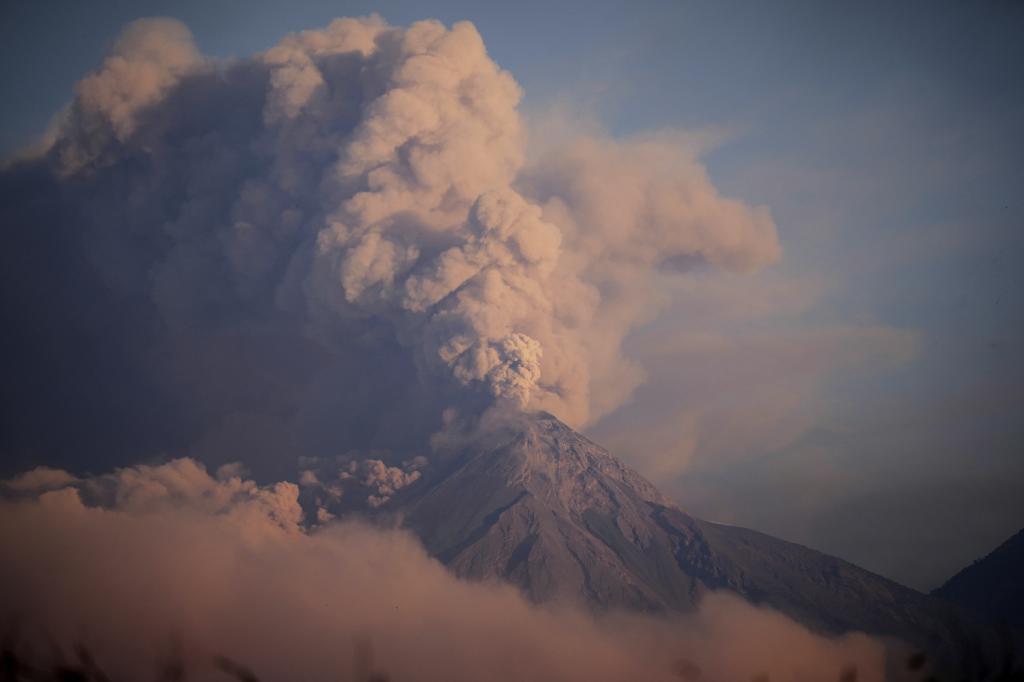 The "Volcan de Fuego," or Volcano of Fire, blows a thick cloud of ash