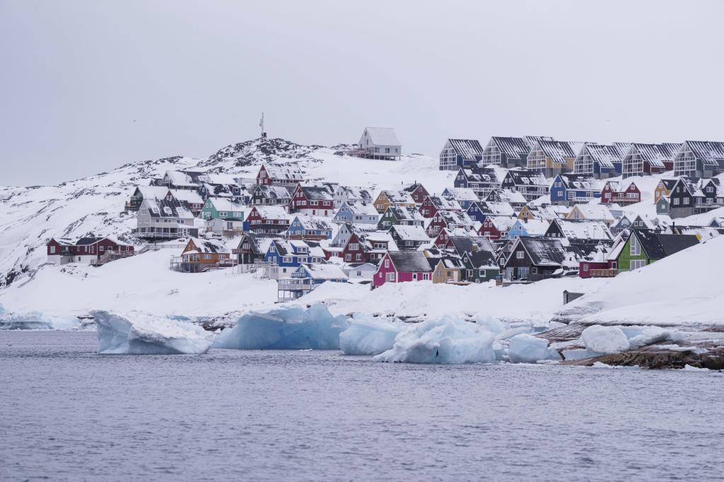 Coloured houses covered by snow are seen from the sea in Nuuk, Greenland