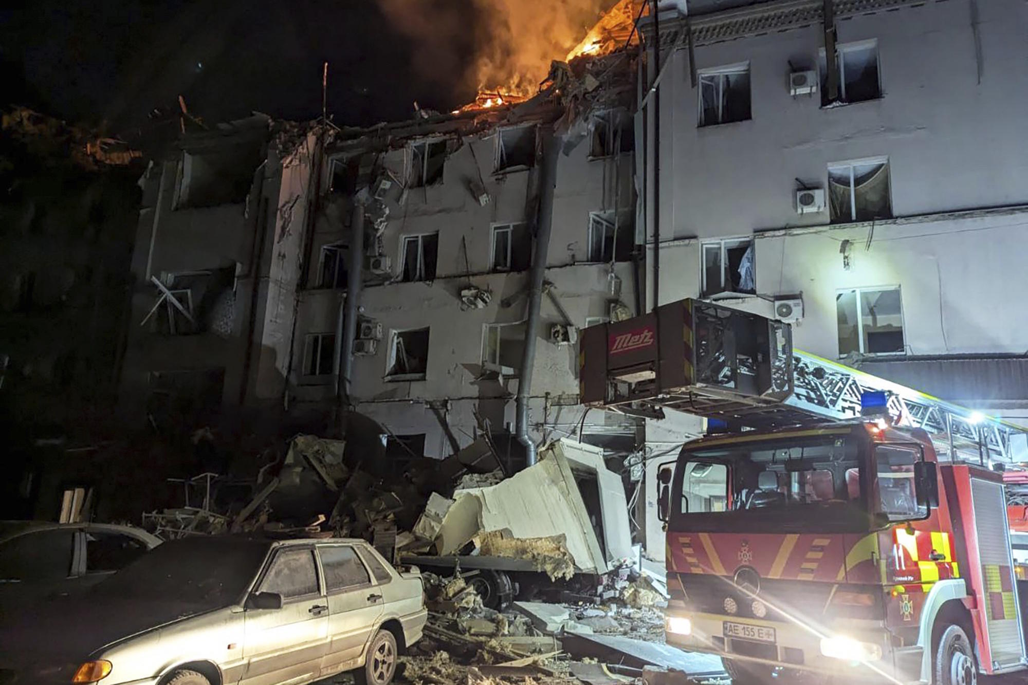 Firefighters work on the site of a damaged building after a Russian missile attack.