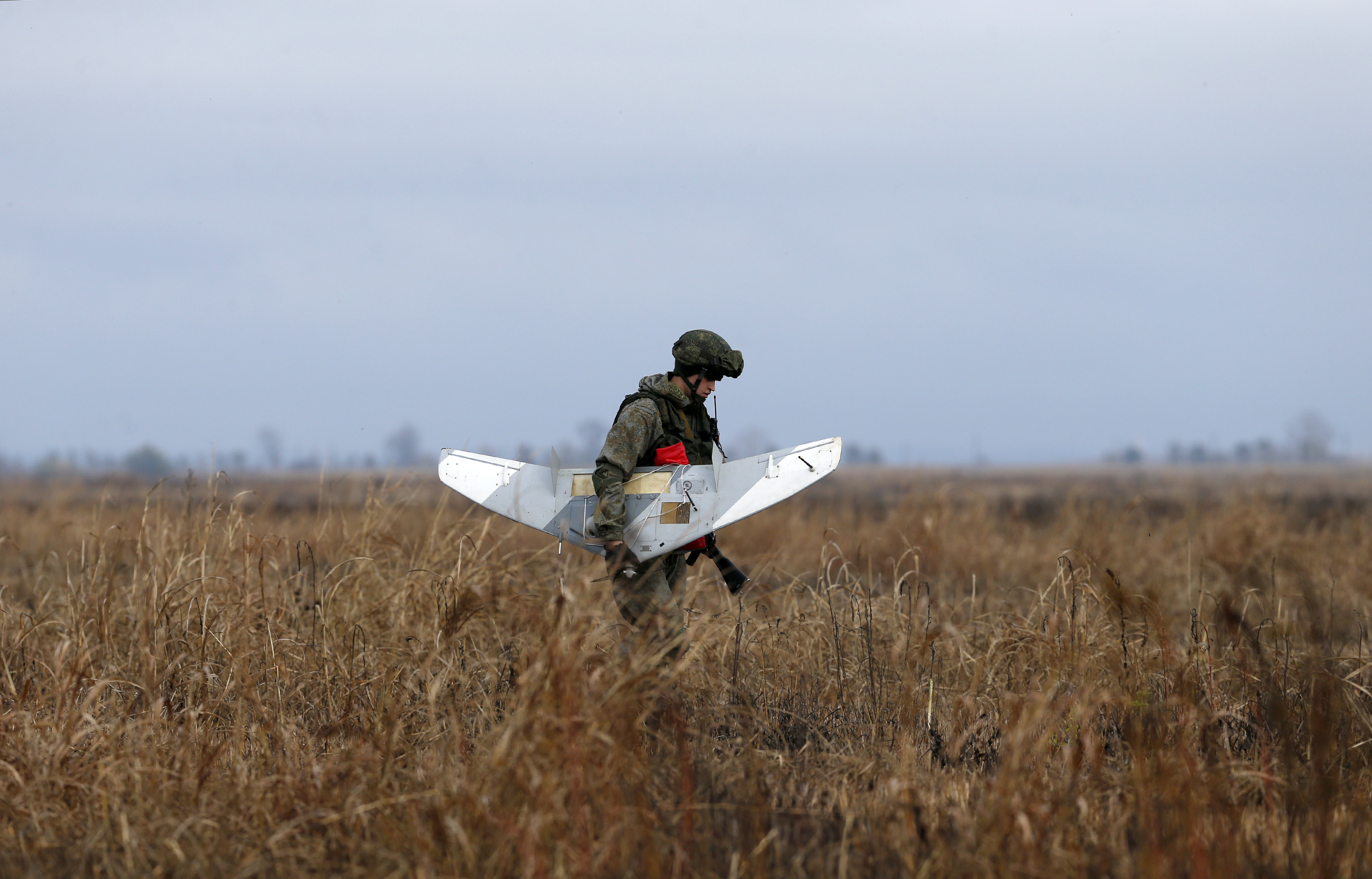 A Russian soldier holds a drone.