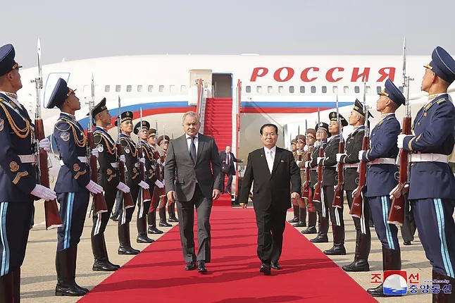 The Secretary of the Security Council of Russia, Sergey Shoigu, is welcomed by the secretary of the ruling party in North Korea, Park Chung-cheon.