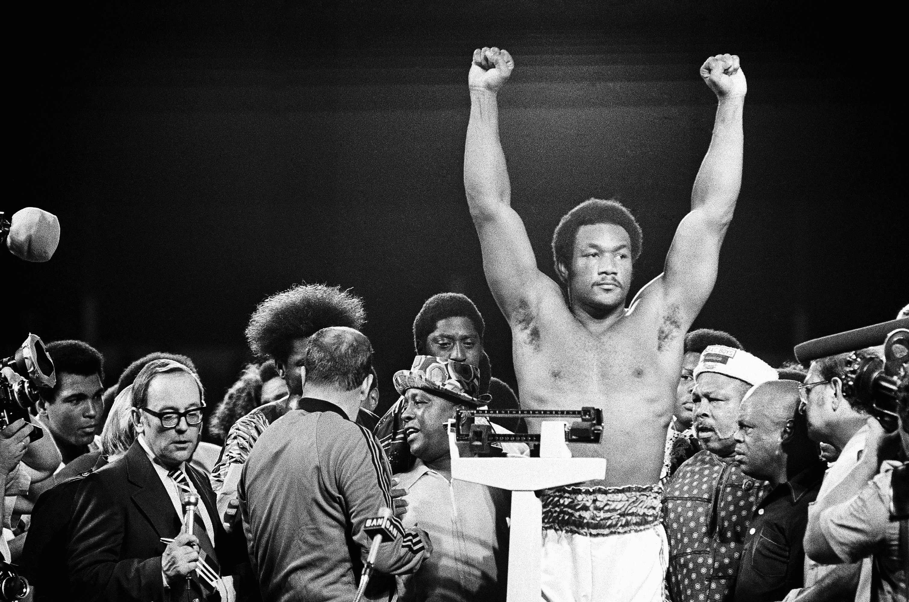 Heavyweight champion George Foreman responds to cheers of crowd in stadium in Kinshasa, Zaire.