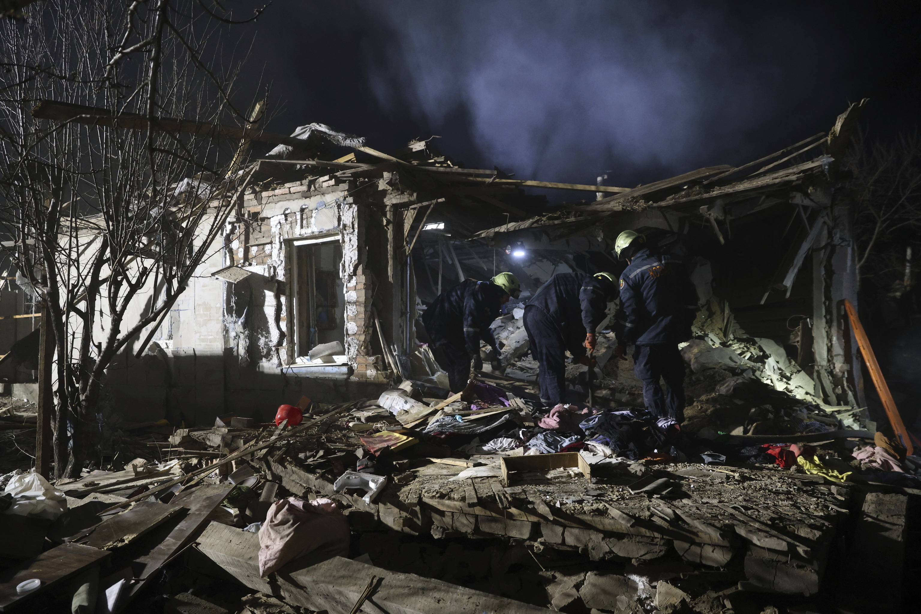 Rescue workers clear the rubble of a residential house destroyed by a Russian drone strike in Zaporizhzhia, Ukraine.