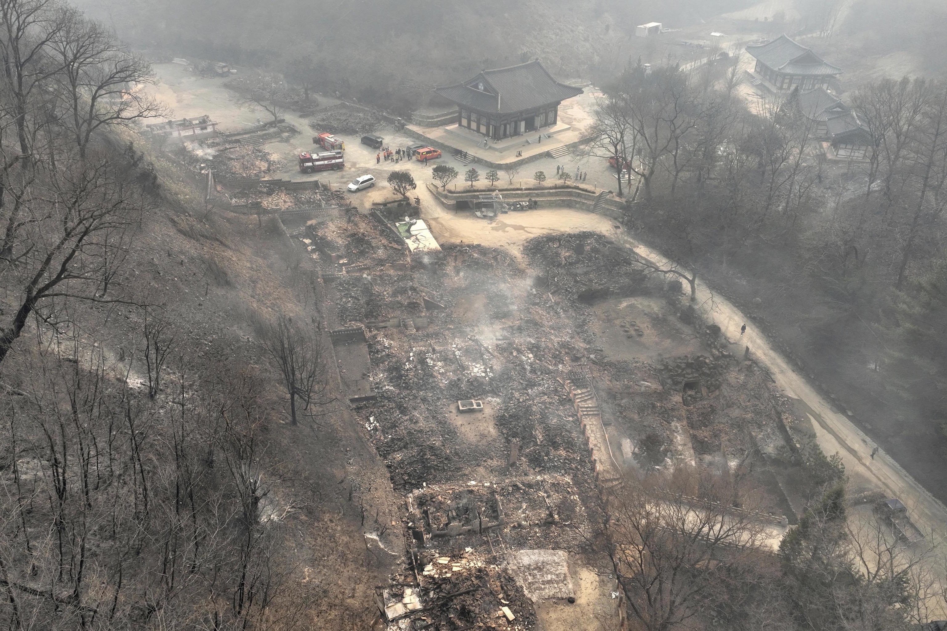 The remains of burnt-out pavilions due to wildfires are seen at the Gounsa temple.