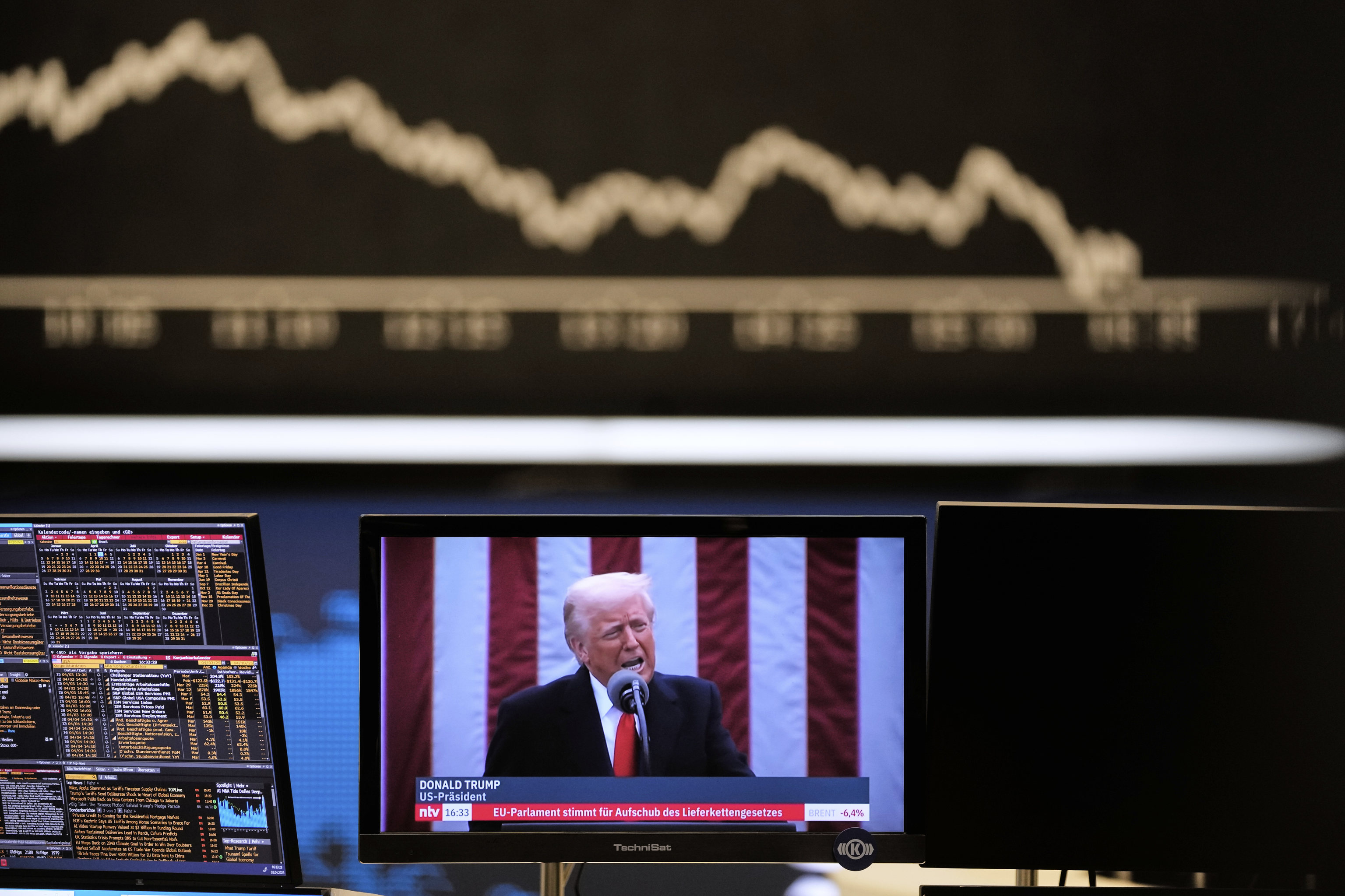 US President Donald Trump appears on a television screen at the stock market in Frankfurt.