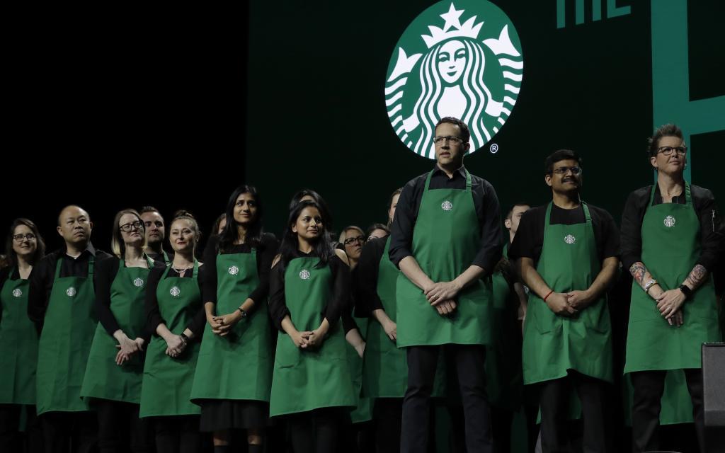 Starbucks baristas stand on stag