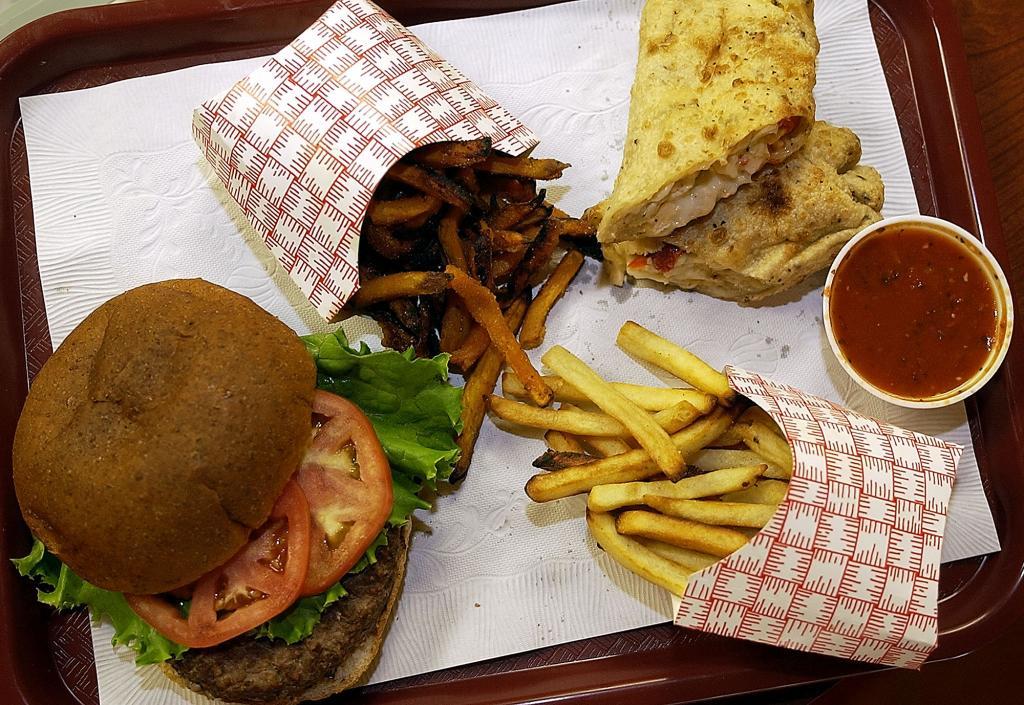 A buffalo beef burger, fries, chicken and sauces