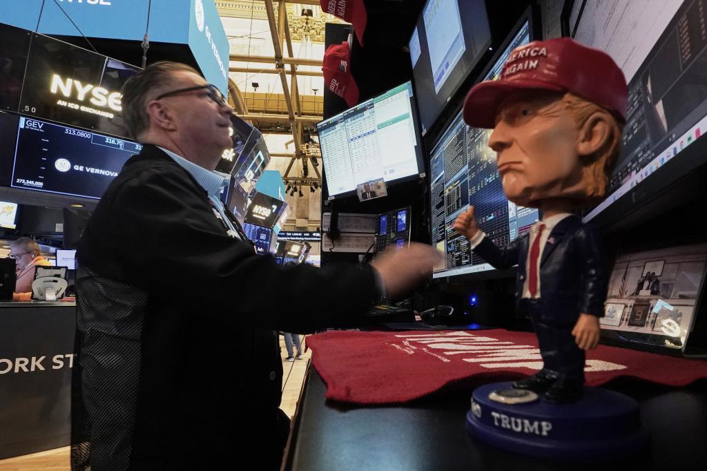 A Donald Trump bobblehead sits on the counter as trader Jonathan Mueller works on the floor of the New York Stock Exchange