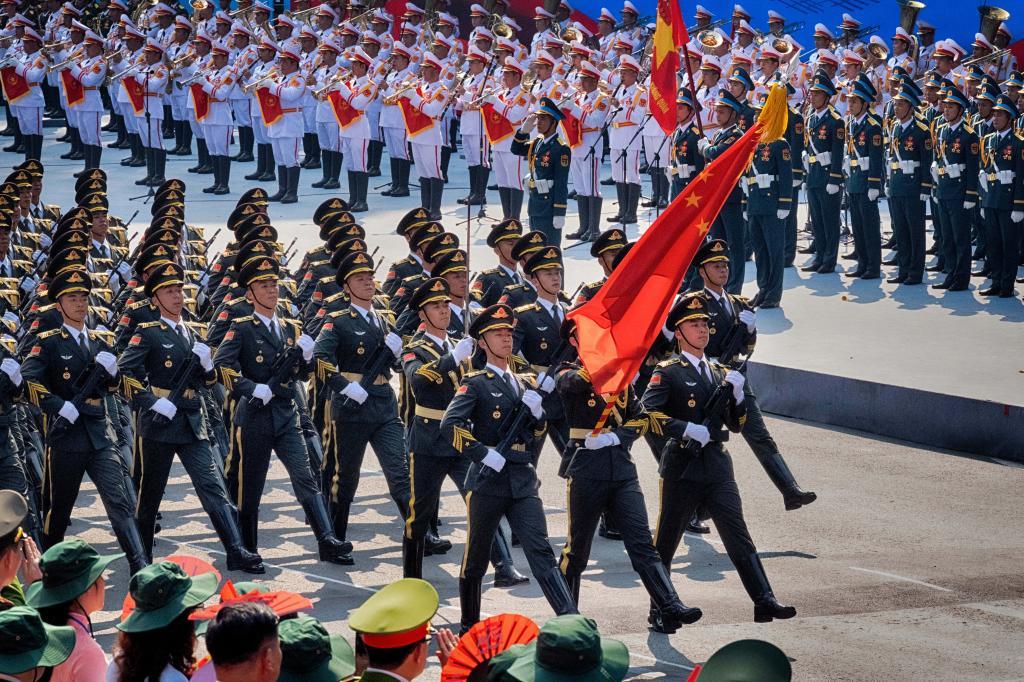 Chinese soldiers participate in a parade during the celebration for the 50th anniversary of the end of the Vietnam War