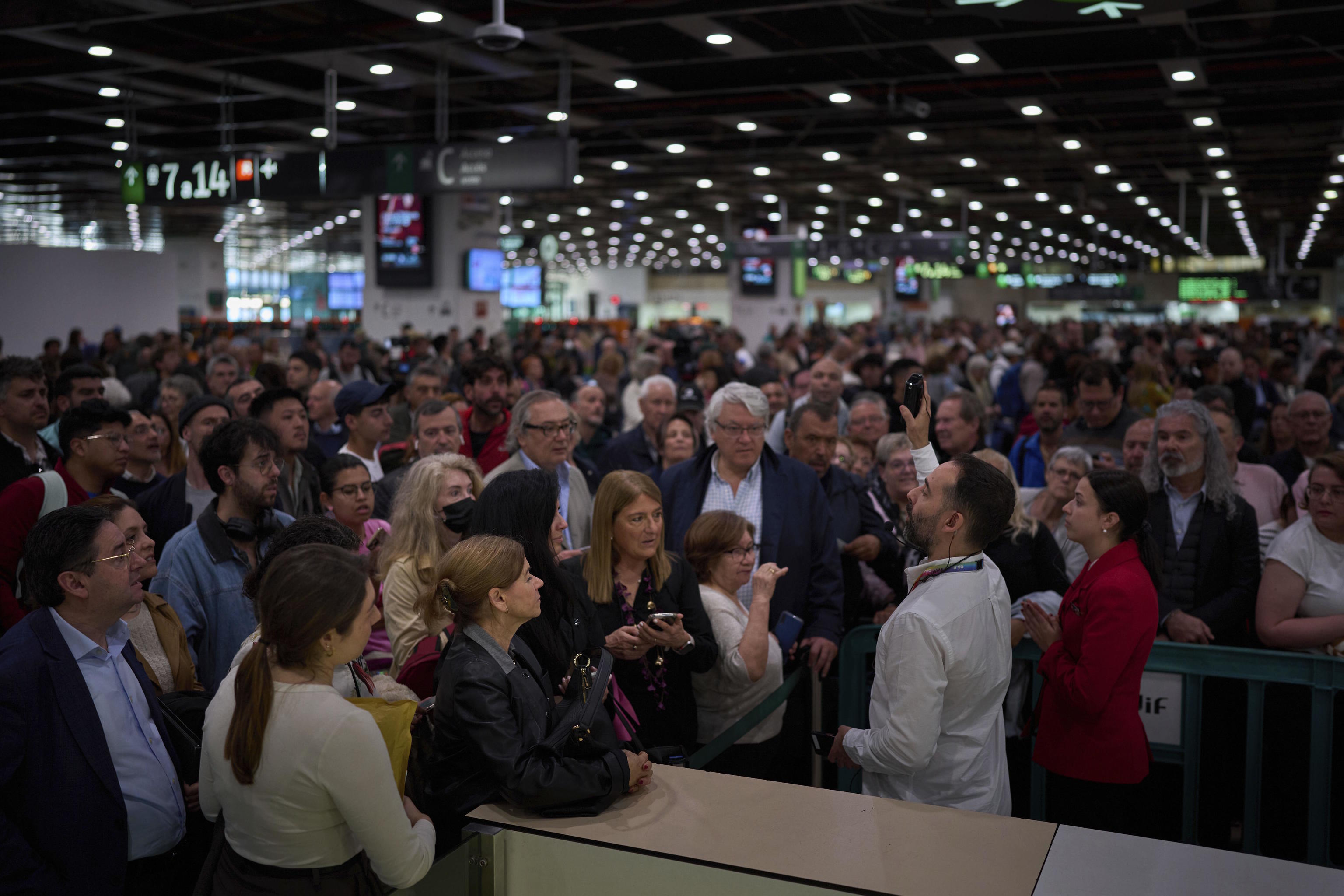 Passengers crowd the entrances to Barcelona's Sants train station.