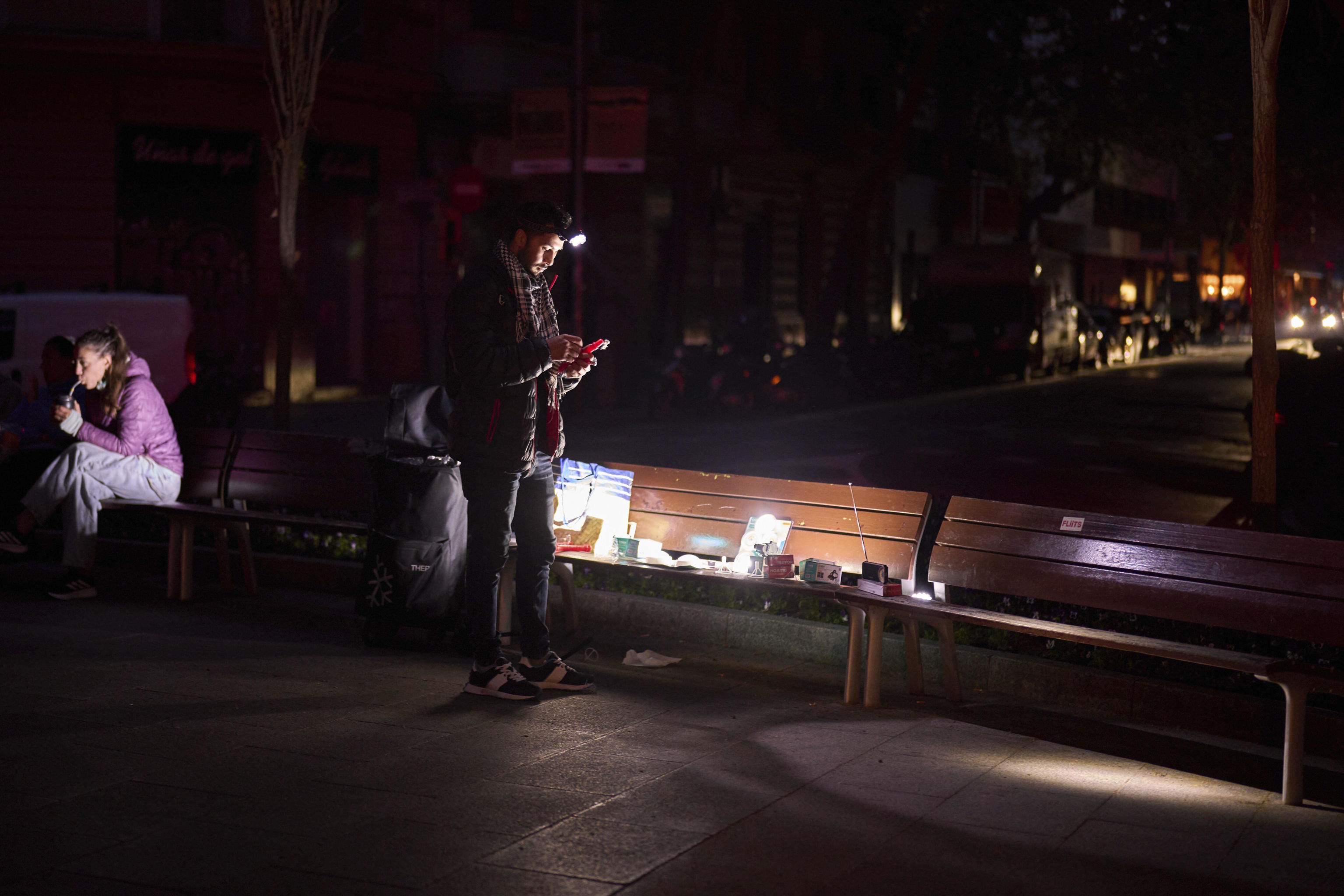 A man sells battery-powered radios and torches on a Barcelona street.