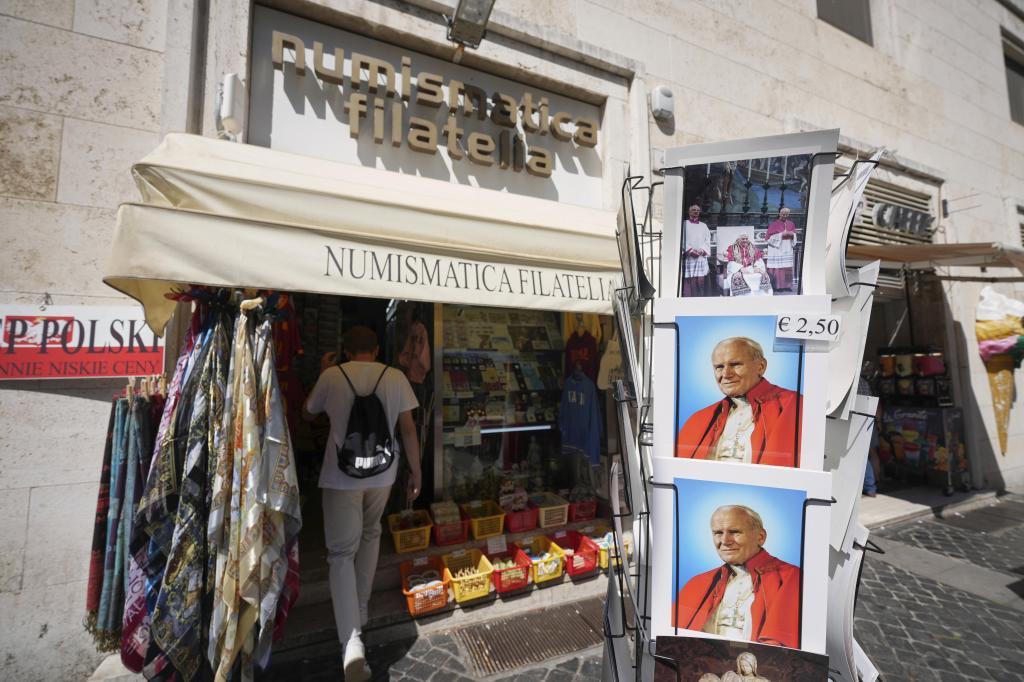 A person enters the Filitalia stamps, coins, and souvenirs shop just next to the Vatican walls in Rome