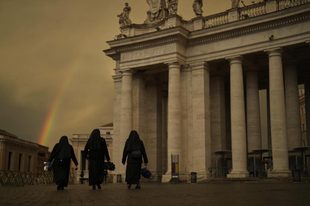 Three nuns walking in St. Peter's Square.
