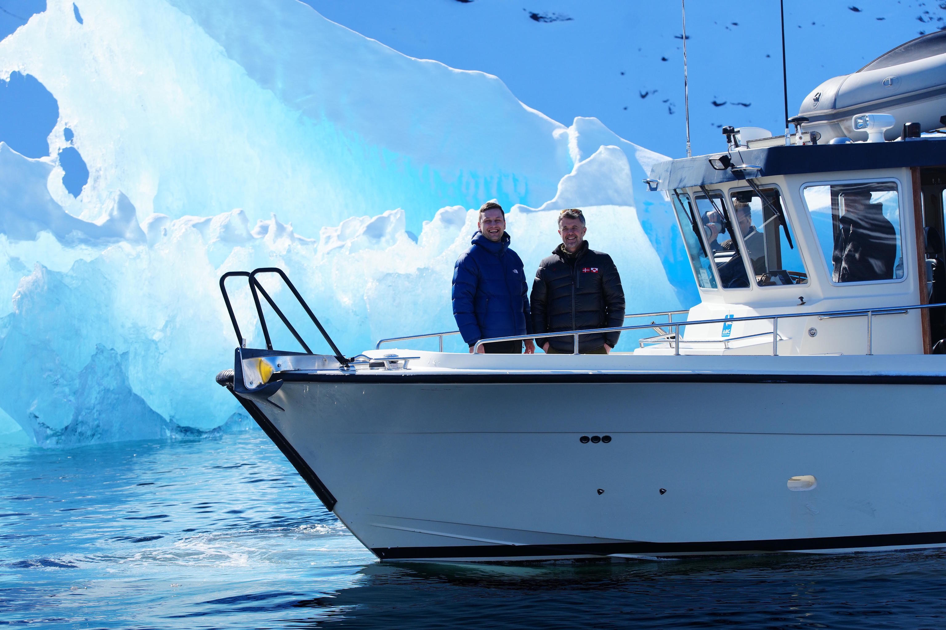 King Frederik of Denmark and the Prime Minister of Greenland during a boat ride on the Nuuk Fjord in Greenland.