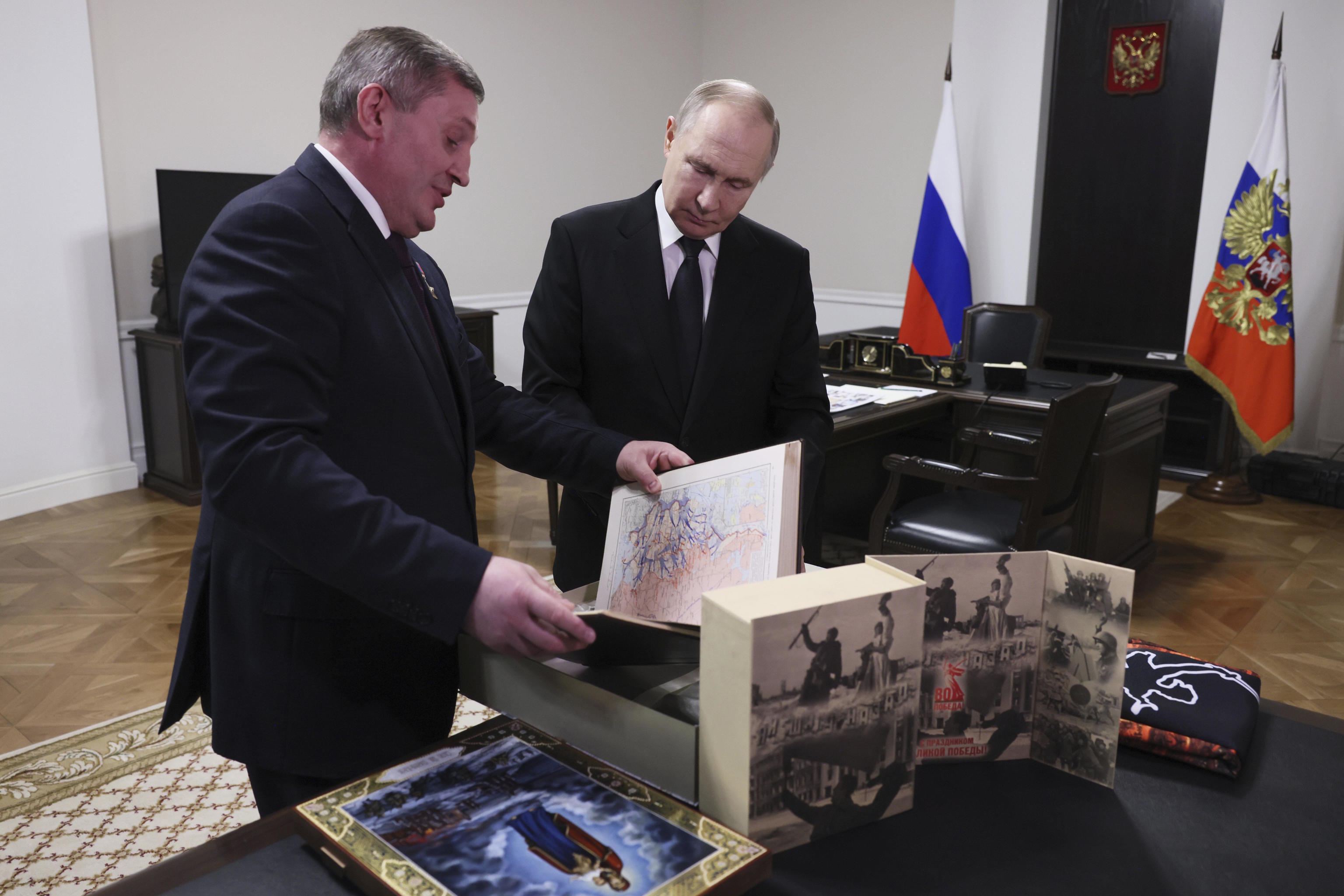 Putin, right, speaks with the Governor of Volgograd region, Andrey Bocharov.