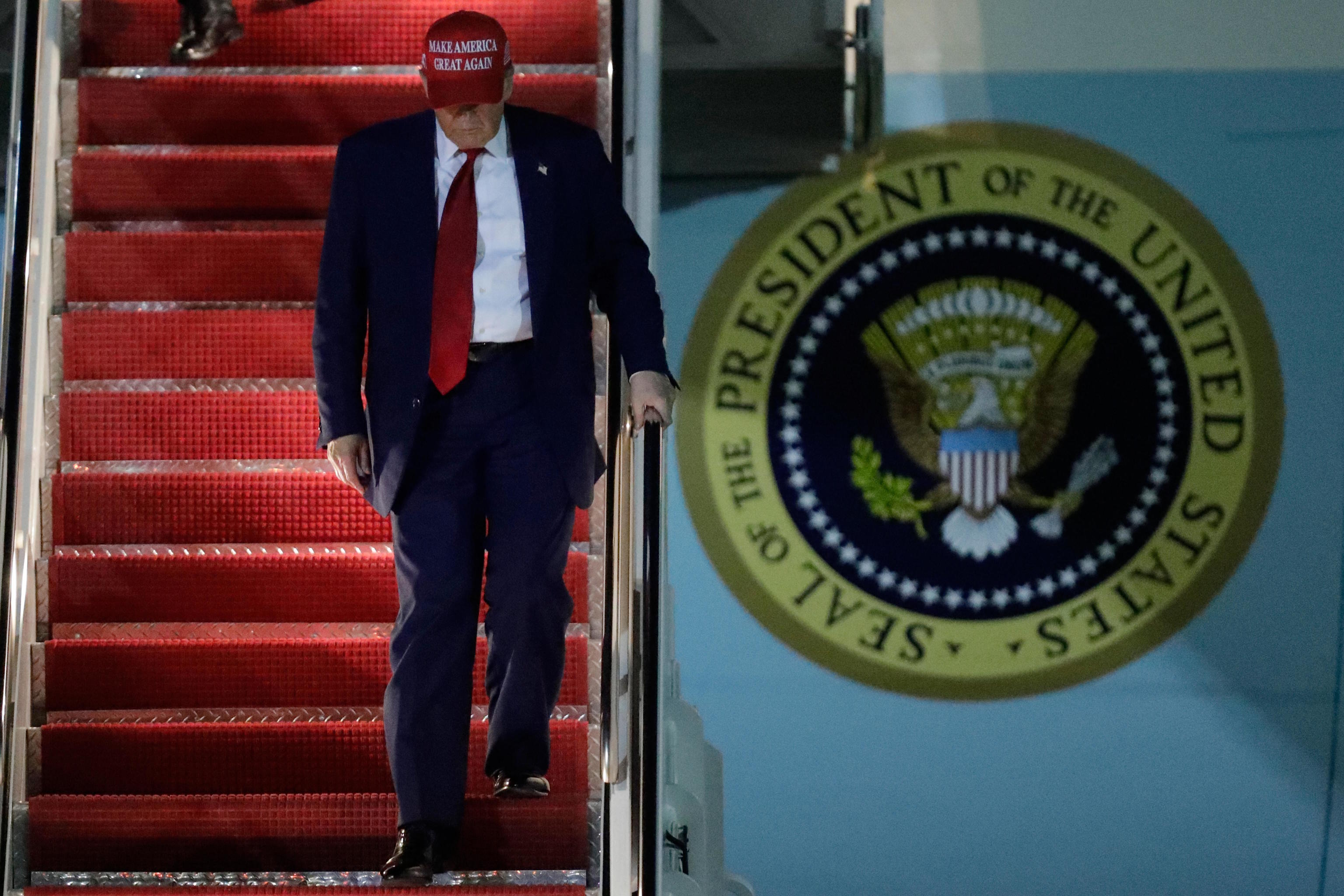 President Donald Trump walks down the stairs of Air Force One.
