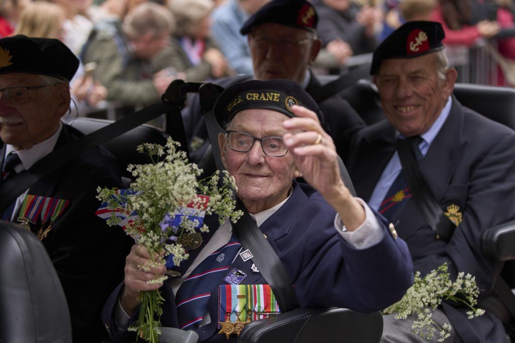 A British World War II veteran of the HMS Crane takes part in a Liberation Day parade