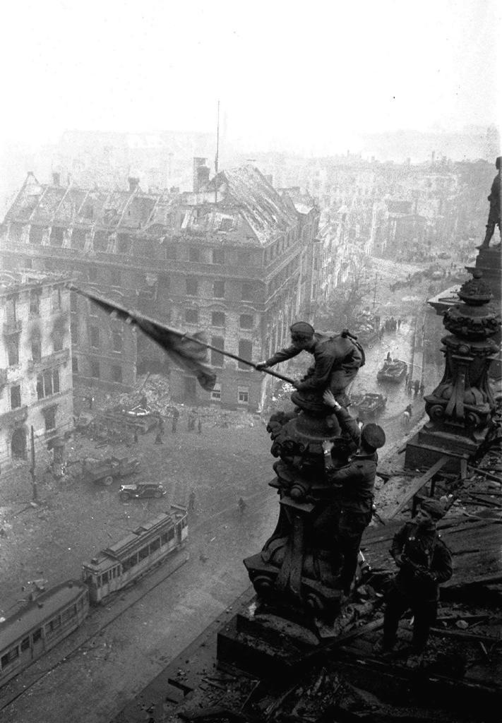 Soviet soldiers hoisting the red flag over the Reichstag in Berlin in this May 1945