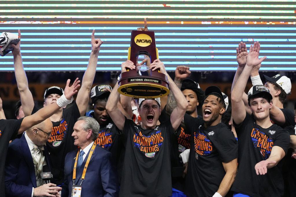 Florida celebrates with the trophy after their win against the Houston in the national championship at the Final Four of the NCAA