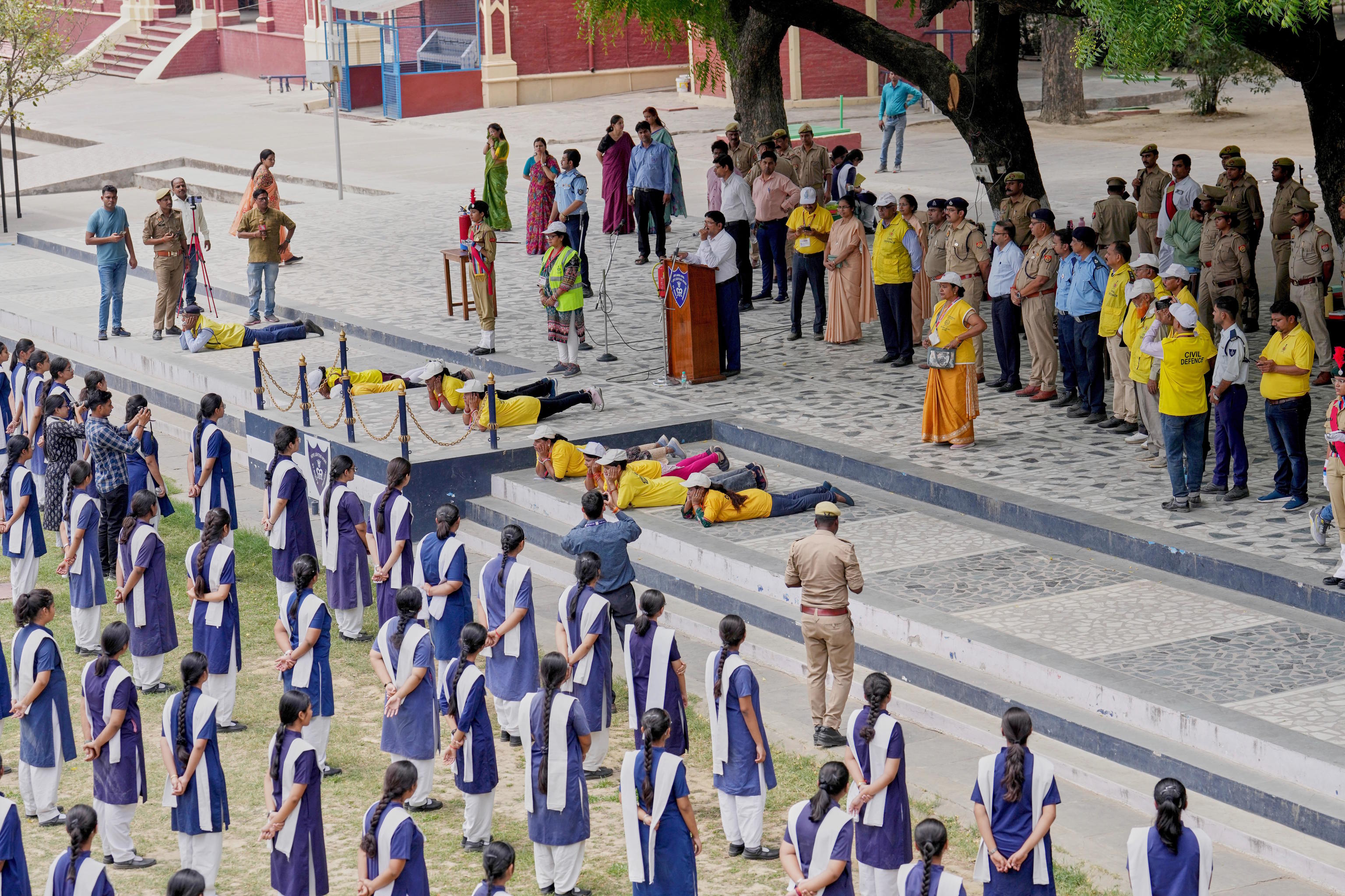 Indian civil defense volunteers and police participate in a mock security drill at a school in Prayagraj, India.